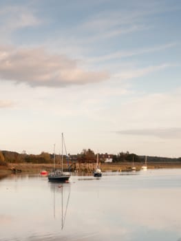 boats in harbour masts landscape river lake water surface clear; essex; england; uk
