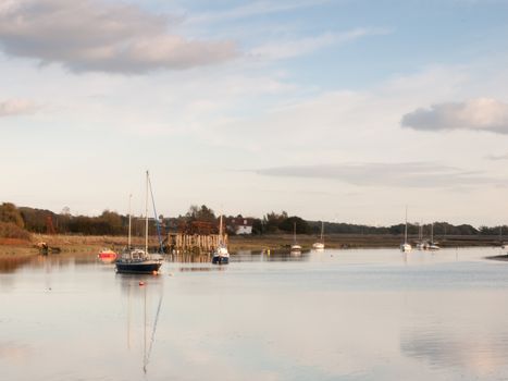 boats in harbour masts landscape river lake water surface clear; essex; england; uk