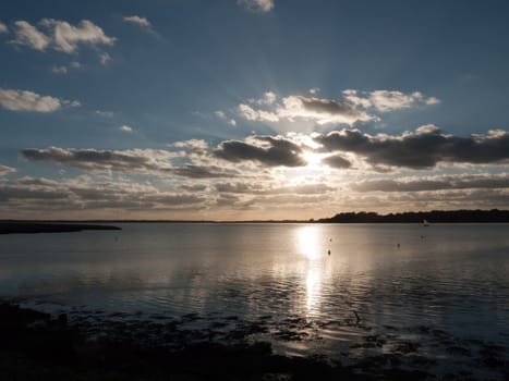 beautiful sunset over harbour coast sea bay clouds silhouette landscape; essex; england; uk