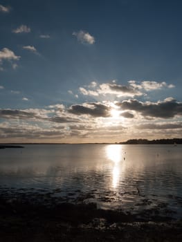 beautiful sunset over harbour coast sea bay clouds silhouette landscape; essex; england; uk