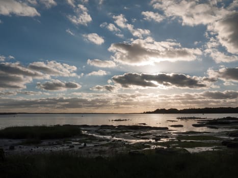 beautiful sunset over harbour coast sea bay clouds silhouette landscape; essex; england; uk