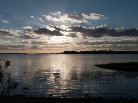 beautiful sunset over harbour coast sea bay clouds silhouette landscape; essex; england; uk