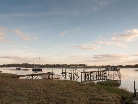 pier harbour boat jetty scene outside bay coast country river lake; essex; england; uk