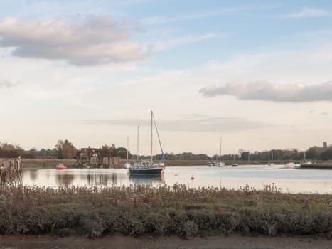 boats in harbour masts landscape river lake water surface clear; essex; england; uk