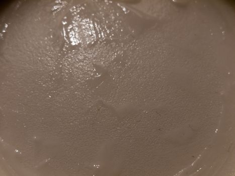 close up of white cream moisturizer inside glass tub; essex; england; uk
