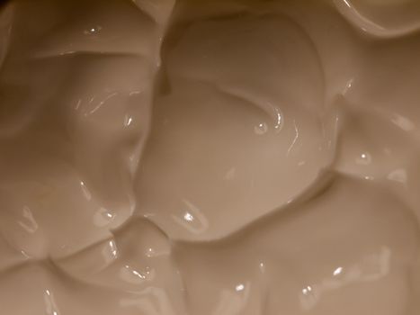 close up of white cream moisturizer inside glass tub; essex; england; uk