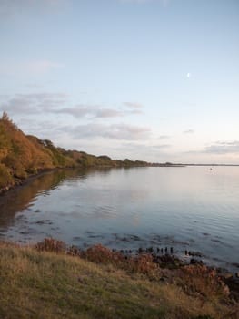 beautiful evening bay scene outside water wave ripples empty open space harbour country; essex; england; uk