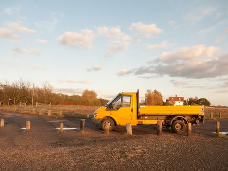 yellow outside environment van parked on gravel ranger; essex; england; uk