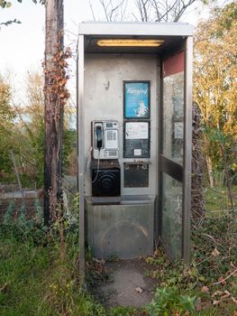 dirty modern telephone box no door empty no people; essex; england; uk