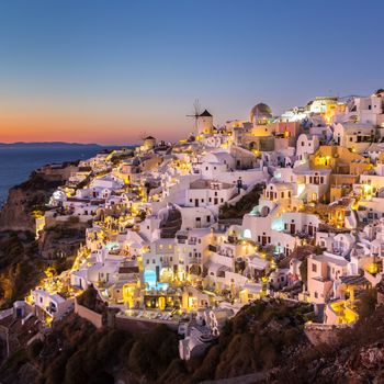 World famous Oia village or Ia at sunset, Santorini island, Greece.