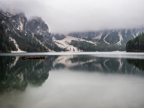 View to beautiful calm lake in forest in mountains.