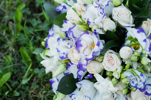 Beautiful wedding bouquet and rings.