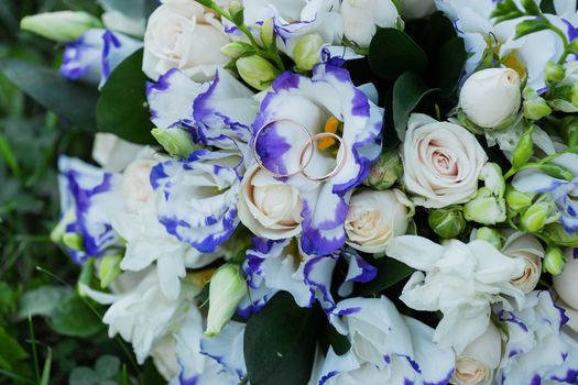 Beautiful wedding bouquet and rings.