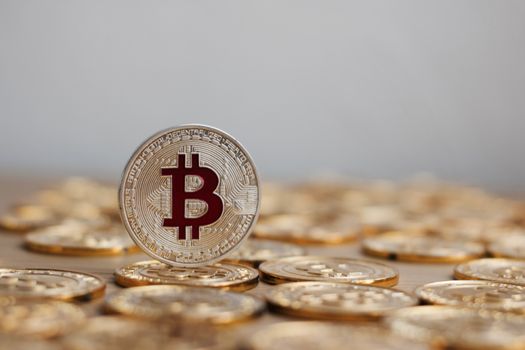 Digital currency physical bitcoin coin. Gold background coins concept.