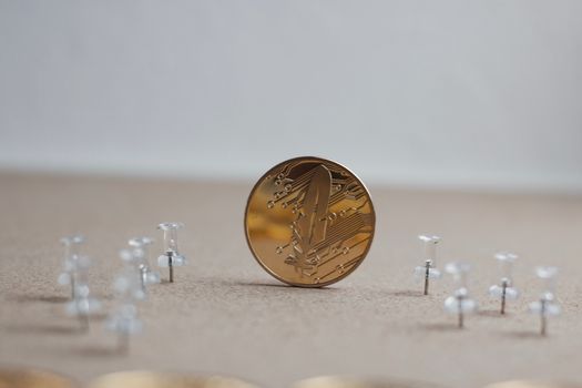 Digital currency physical gold feather coin. Cinema cryptocurrency concept.