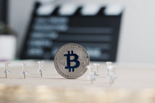 Digital currency physical metal bitcoin coin. Cryptocurrency cinema concept.