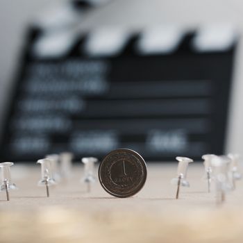 Physical polish coin near cinema board. Polish money lifestyle concept.