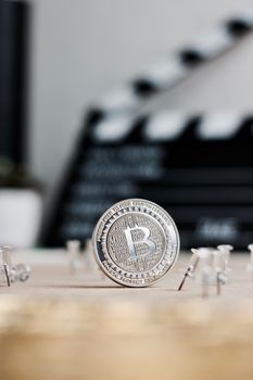 Digital currency physical metal bitcoin coin. Cryptocurrency cinema concept.