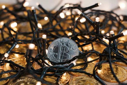 Digital currency physical metal bitcoin coin on the christmas concept.