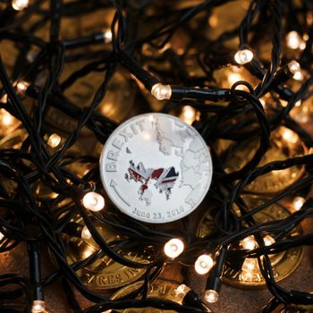 Europe leaving. Article 50 physical brexit coin with british map. Christmas concept.