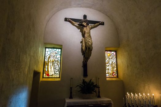Jesus Christ on the cross statue in an ancient medieval chapel