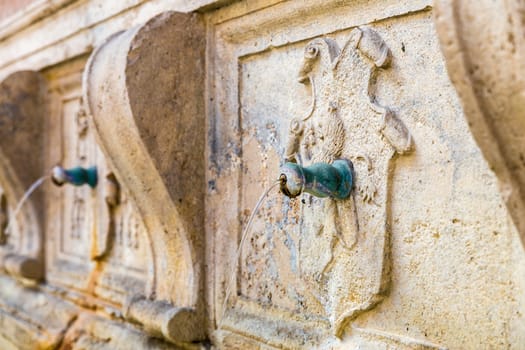 detail of an ancient fountain in Assisi (Italy)