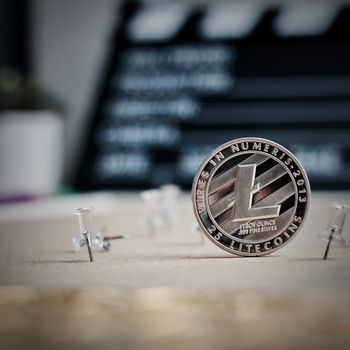 Digital currency physical metal litecoin coin. Cryptocurrency video concept.