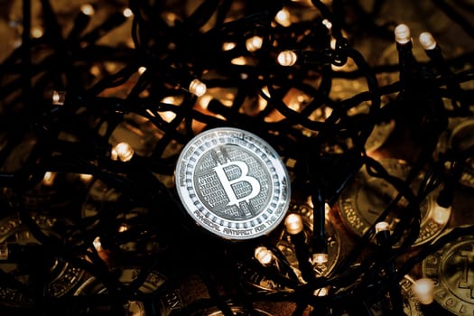 Digital currency physical metal bitcoin coin on the christmas concept.