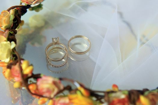 Wedding rings on a blue satiny fabric