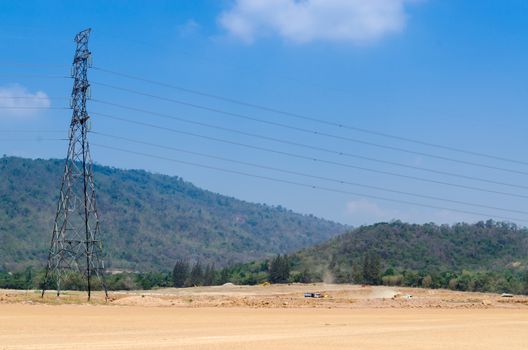 High voltage power lines electric pole in nature.