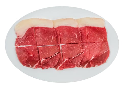 Top view of some raw beef fillets on a plate with  white background