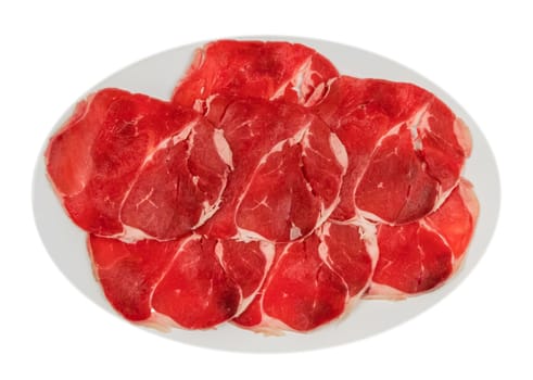 Top view of some raw beef fillets on a plate with  white background