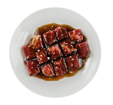 Top view of some raw beef fillets on a plate with  white background