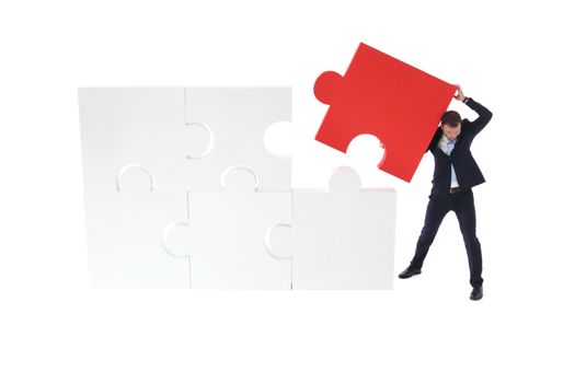 Business pushing the final piece of puzzle isolated on white