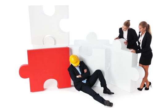 Coworkers look at tired foreman sleeping near puzzle isolated on white background