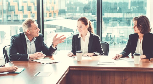 Image of business partners discussing documents and ideas at meeting