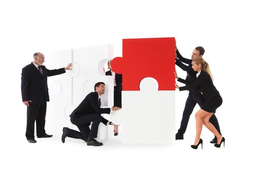 Business team assembling big puzzle isolated on white background