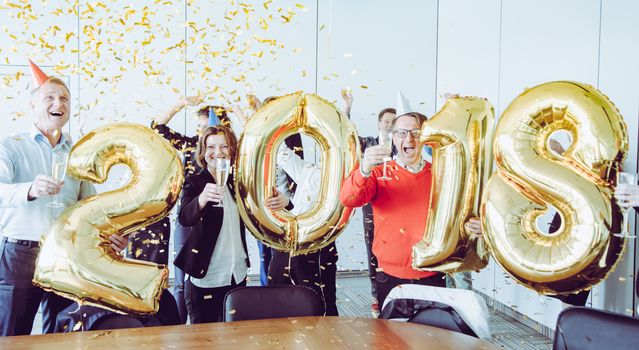 Business people celebrating 2018 New Year at office party