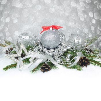 Christmas card with silver baubles and gifts on glitter bokeh light background with copyspace