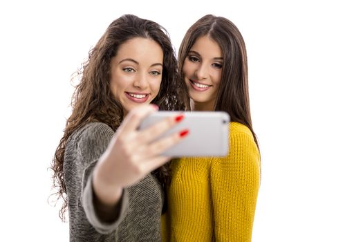 Teen girls with smartphone taking selfie