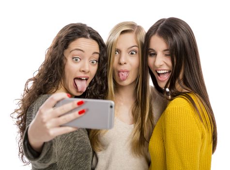 Teen girls with smartphone taking selfie