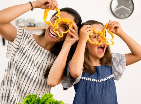 Shot of a mother and daughter having fun in the kitchen