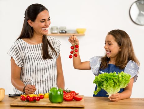 Shot of a mother and daughter having fun in the kitchen