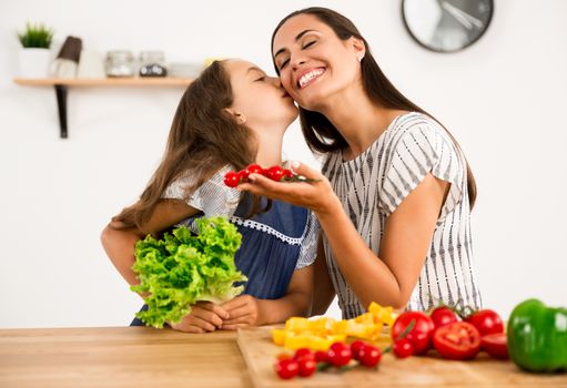 Shot of a mother and daughter having fun in the kitchen