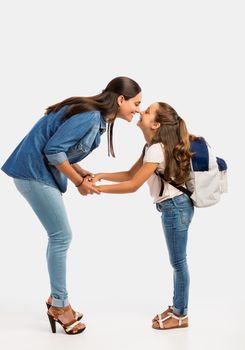 Mother saying goodbye to her daughter on first day of school