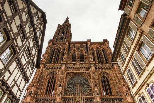 Cathedrale Notre-Dame or Cathedral of Our Lady of Strasbourg behing famous typical half-timbered houses, Alsace, France