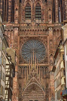 Close up on the Cathedrale Notre-Dame or Cathedral of Our Lady of Strasbourg behing famous typical half-timbered houses, Alsace, France
