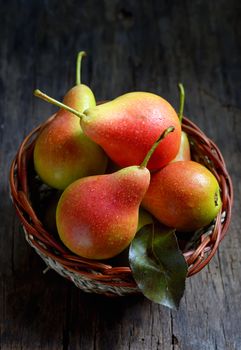 Pears in a basket on wooden table
