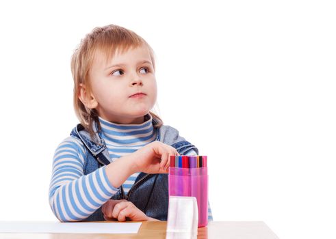 Little Girl drawing picture at table isolated on white