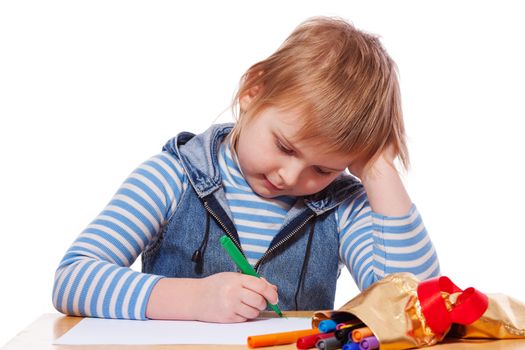 Little Girl drawing picture at table isolated on white